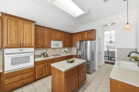 a kitchen with a sink stove and refrigerator