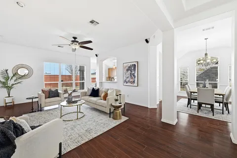 a living room with furniture and wooden floor