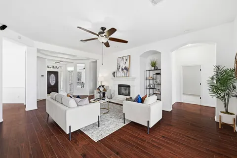 a living room with fireplace furniture and a wooden floor