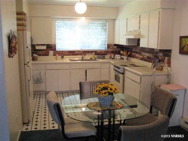 a view of a dining room with furniture and window