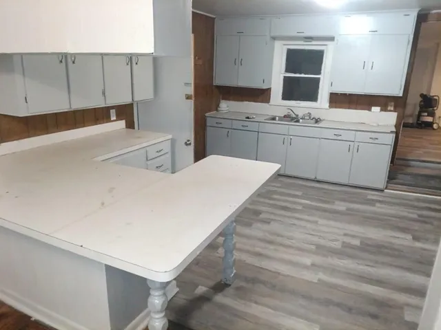 a kitchen with a sink a stove and cabinets