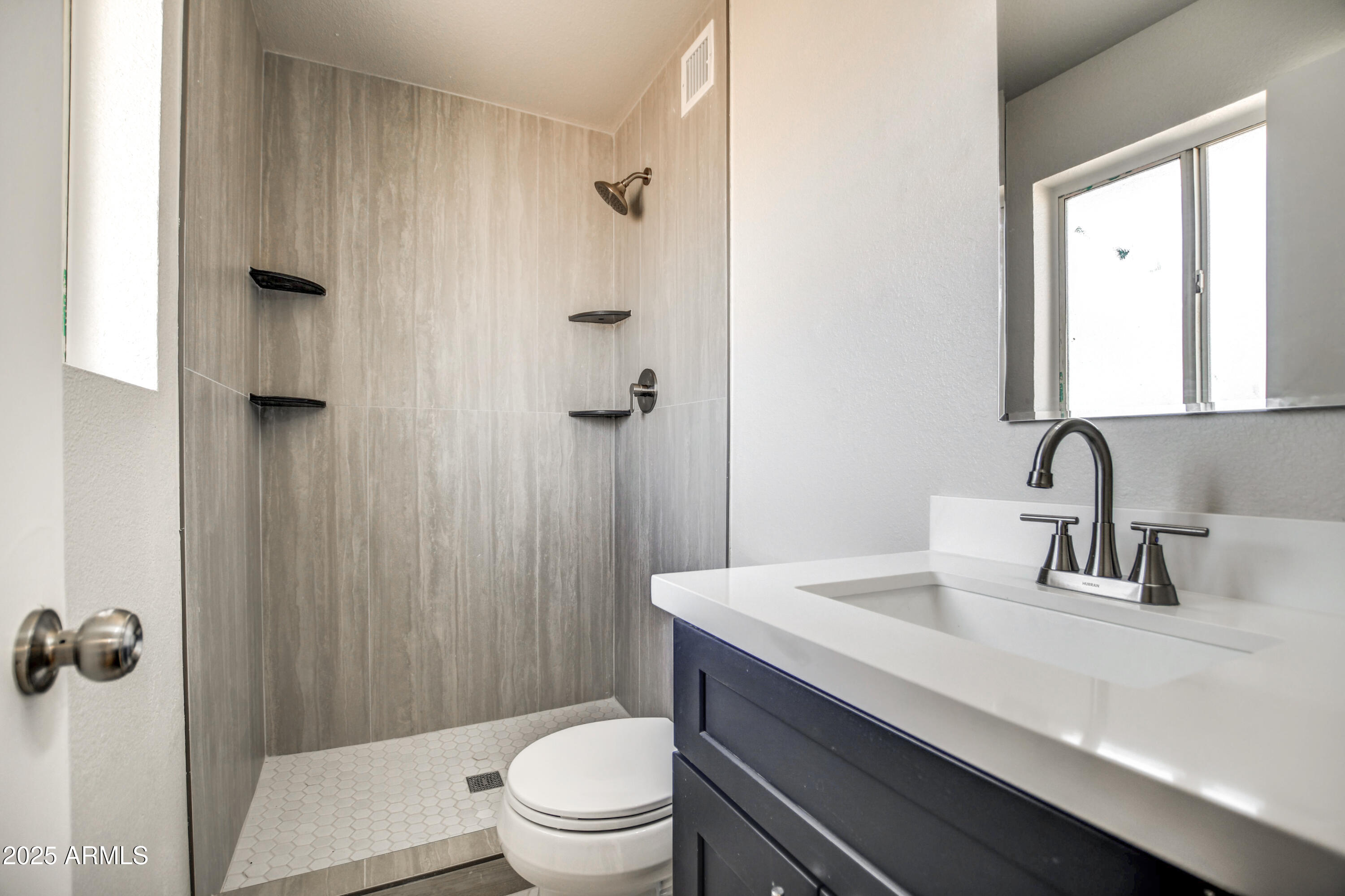 4870 West Almeria Road Phoenix, AZ 85035 - Photo 12 of 22 a bathroom with a sink a toilet and shower