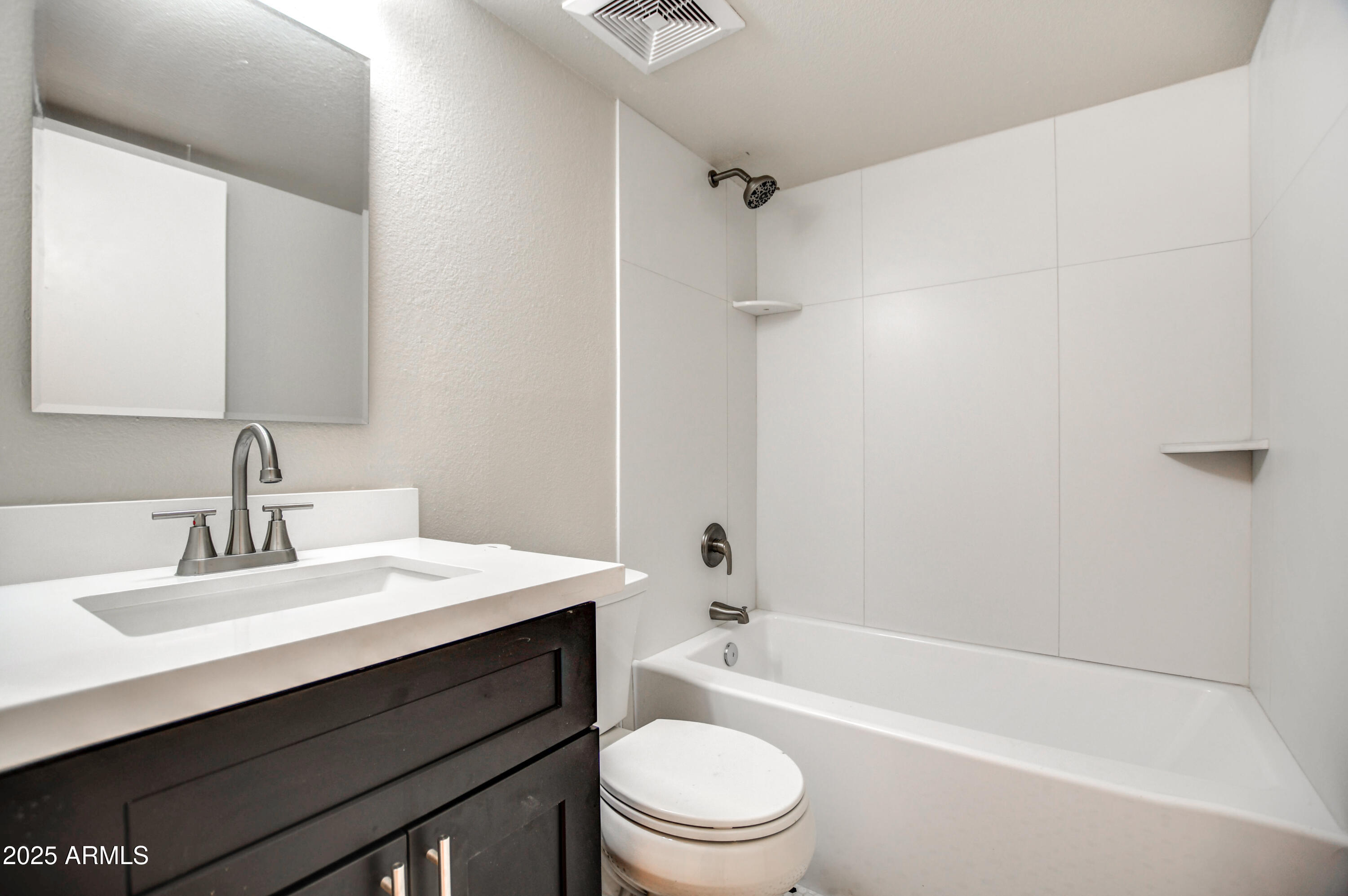 4870 West Almeria Road Phoenix, AZ 85035 - Photo 16 of 22 a bathroom with a sink a toilet and shower