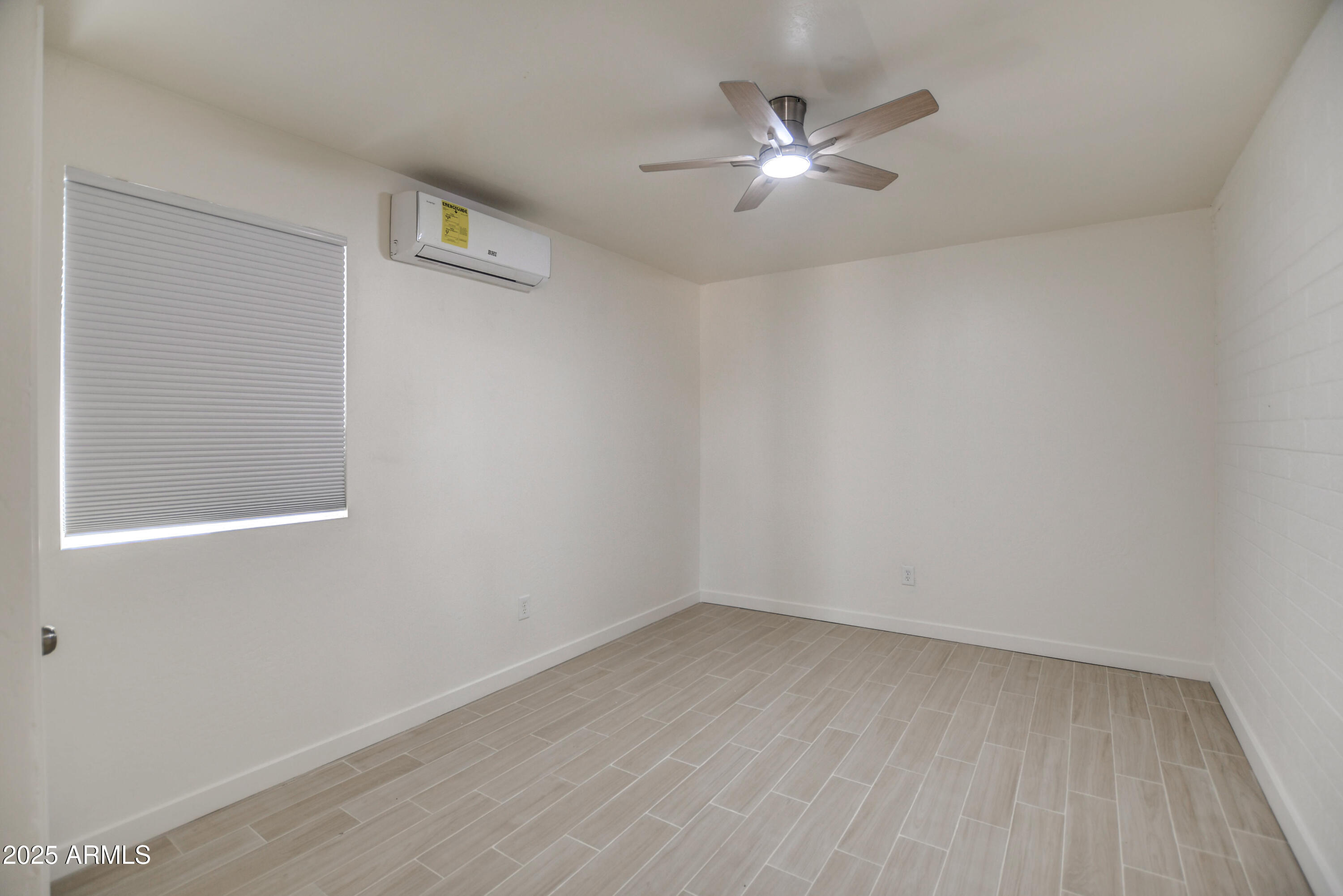 4870 West Almeria Road Phoenix, AZ 85035 - Photo 18 of 22 wooden floor in an empty room with a window