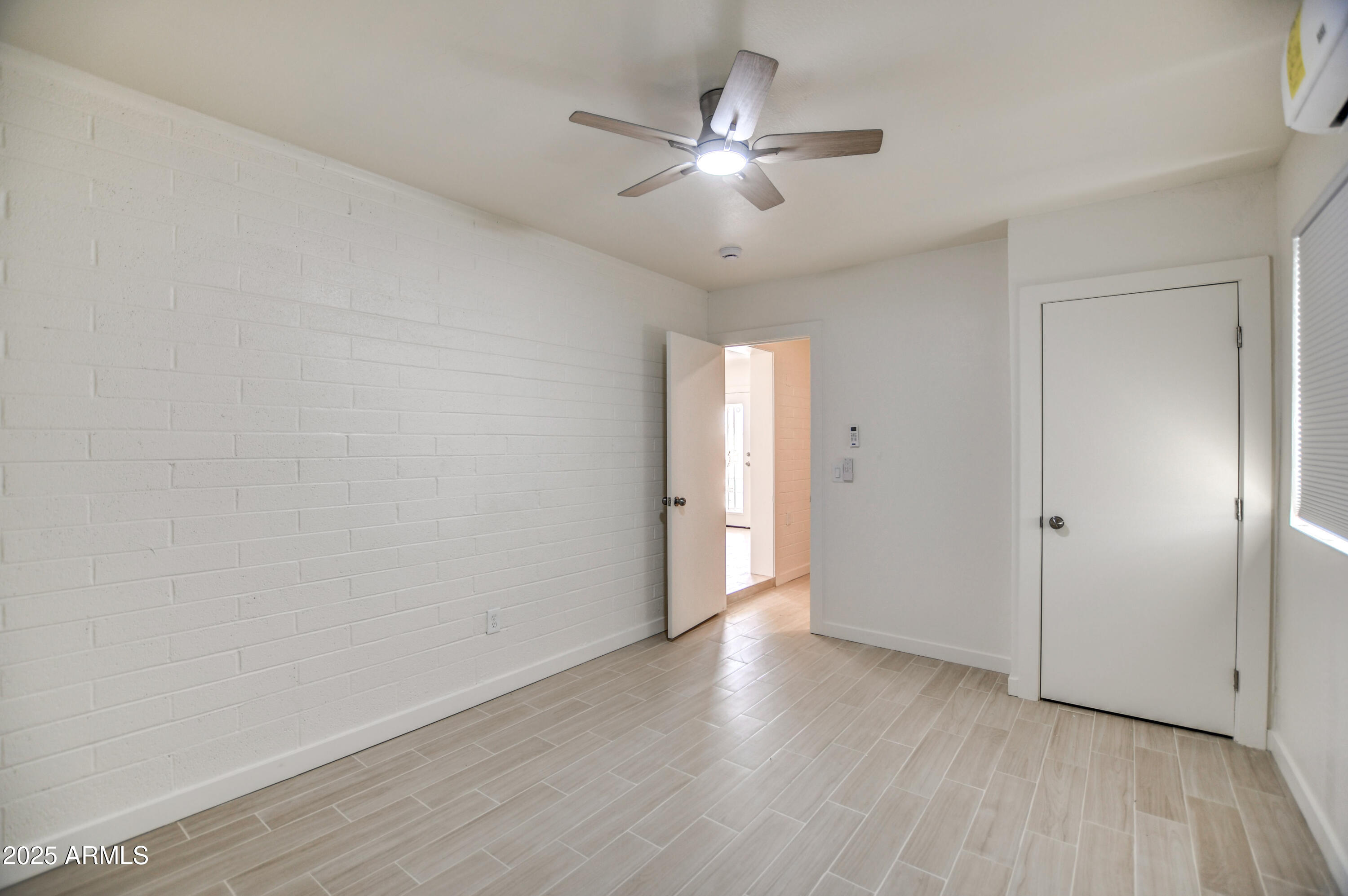 4870 West Almeria Road Phoenix, AZ 85035 - Photo 19 of 22 a view of an empty room with wooden floor