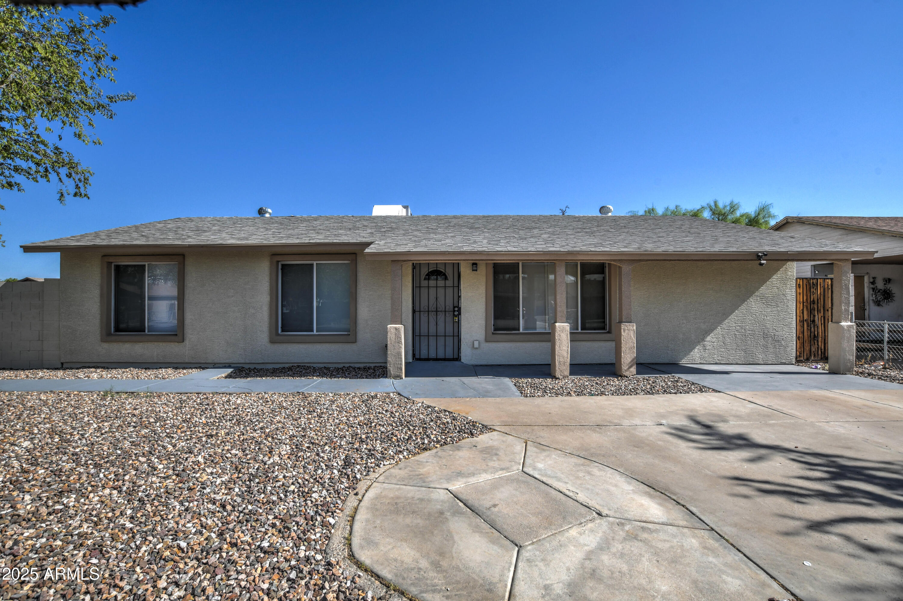 4870 West Almeria Road Phoenix, AZ 85035 - Photo 2 of 22 a front view of a house with a garden