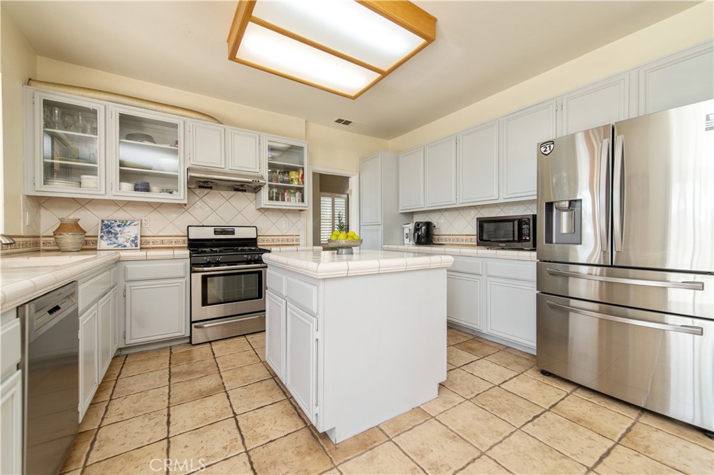 9111 Hamilton Street Rancho Cucamonga, CA 91701 - Photo 15 of 46 a kitchen with cabinets and steel appliances