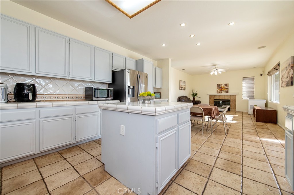 9111 Hamilton Street Rancho Cucamonga, CA 91701 - Photo 16 of 46 a kitchen with stainless steel appliances kitchen island granite countertop a sink and cabinets