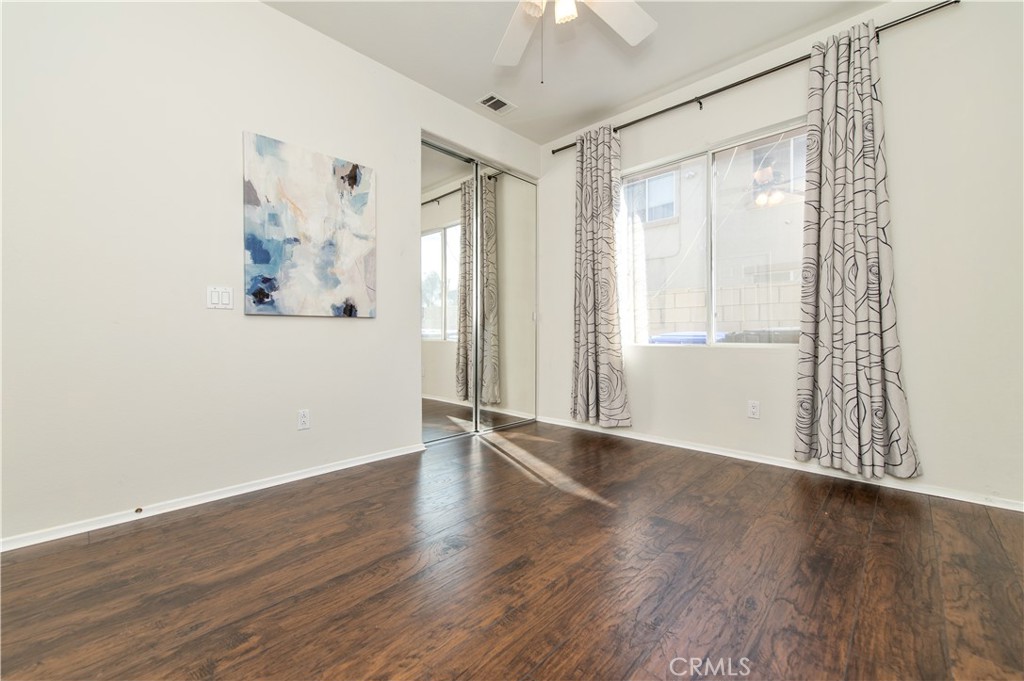 9111 Hamilton Street Rancho Cucamonga, CA 91701 - Photo 19 of 46 an empty room with wooden floor and windows