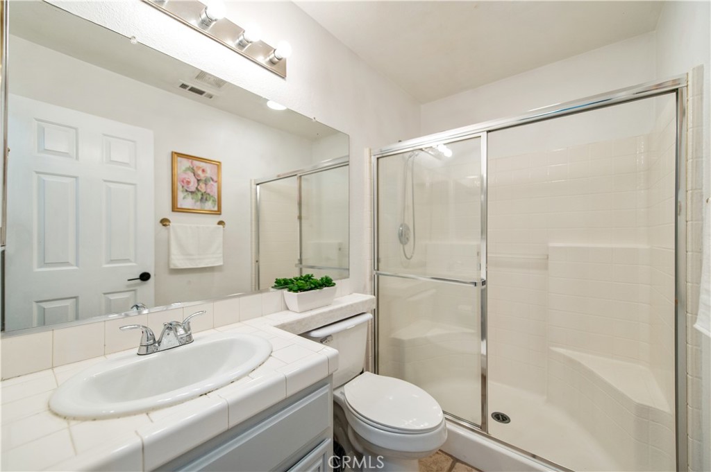 9111 Hamilton Street Rancho Cucamonga, CA 91701 - Photo 20 of 46 a bathroom with a sink toilet and shower