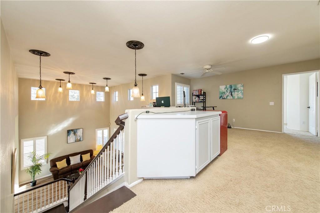 9111 Hamilton Street Rancho Cucamonga, CA 91701 - Photo 24 of 46 a kitchen with stainless steel appliances kitchen island a stove a sink a center island and cabinets