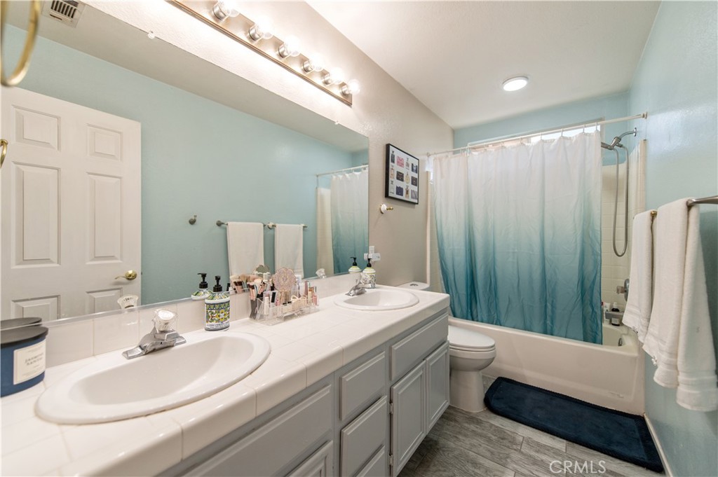 9111 Hamilton Street Rancho Cucamonga, CA 91701 - Photo 36 of 46 a bathroom with a double vanity sink mirror and toilet
