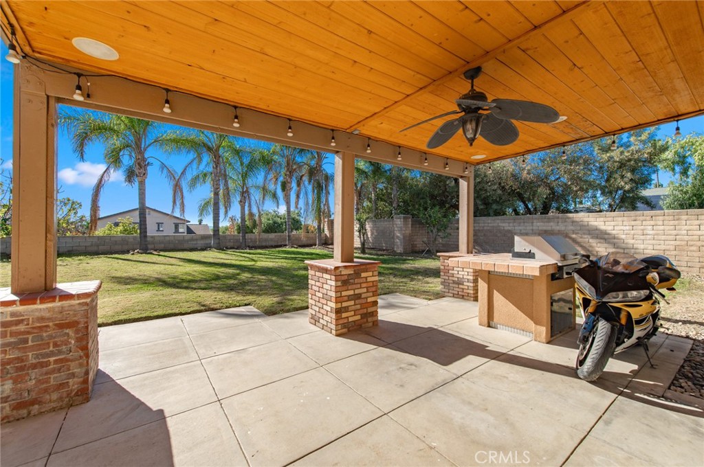 9111 Hamilton Street Rancho Cucamonga, CA 91701 - Photo 39 of 46 a view of a patio with a table and chairs under an umbrella
