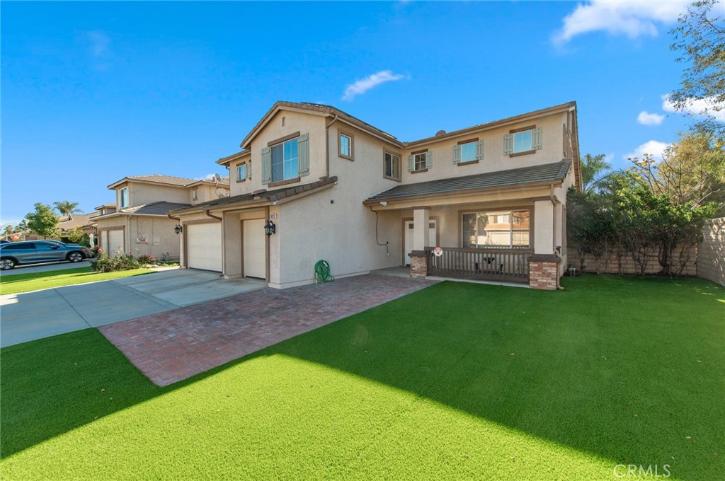 9111 Hamilton Street Rancho Cucamonga, CA 91701 - Photo 45 of 46 a front view of a house with a garden and yard