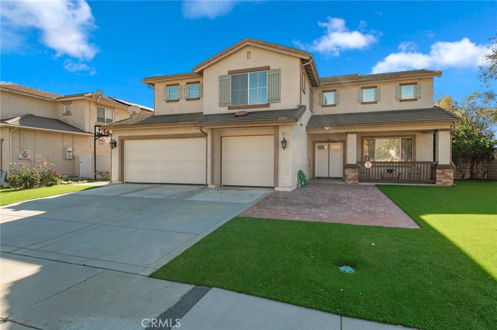 9111 Hamilton Street Rancho Cucamonga, CA 91701 - Photo 46 of 46 a front view of a house with a yard and garage