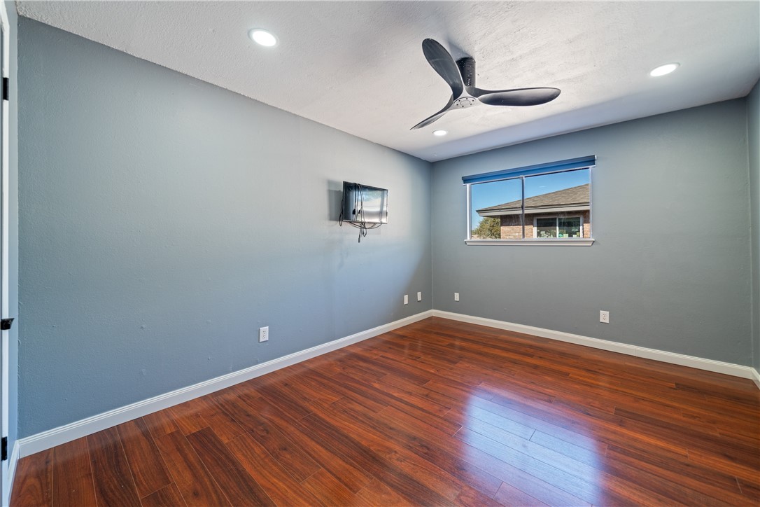 2217 Post Oak Drive Portland, TX 78374 - Photo 26 of 39 an empty room with wooden floor and ceiling fan