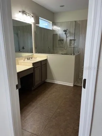 a bathroom with a sink vanity and mirror