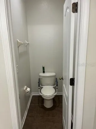 a white toilet sitting in a bathroom next to a sink