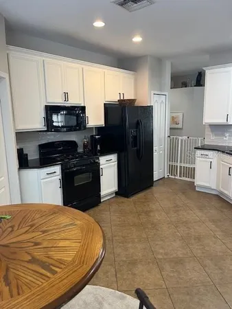 a kitchen with stainless steel appliances granite countertop a refrigerator stove top oven a sink and dishwasher