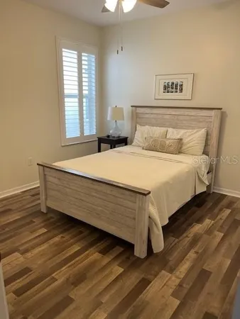 a bed sitting in a bedroom next to a window