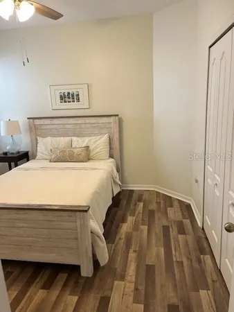 a bed room with a bed and a night stand