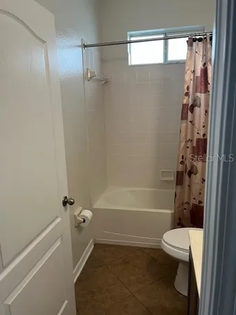 a bathroom with a shower and a toilet