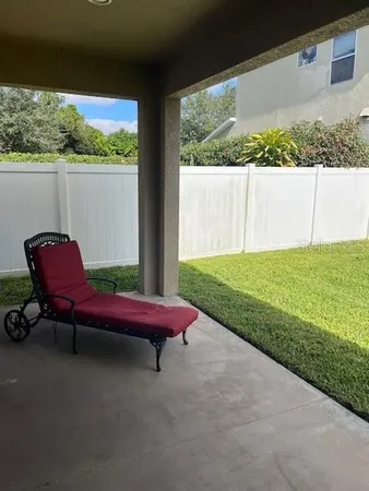 a backyard of a house with table and chairs