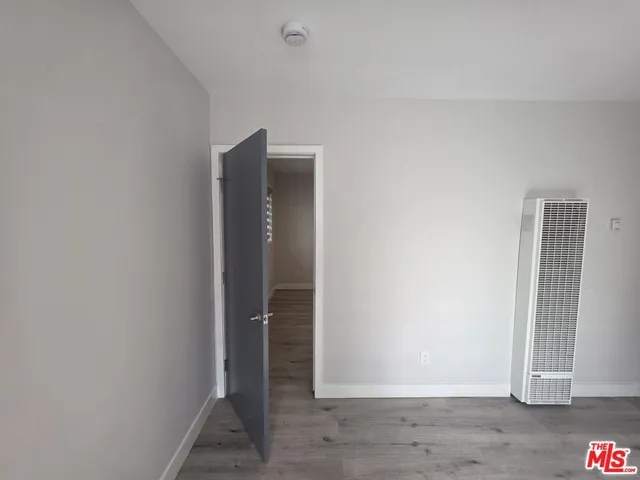 an empty room with wooden floor