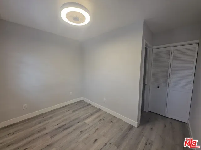 a view of a room with wooden floor and window
