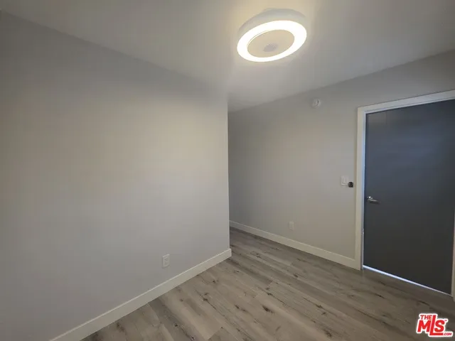 a view of a room with wooden floor and fan