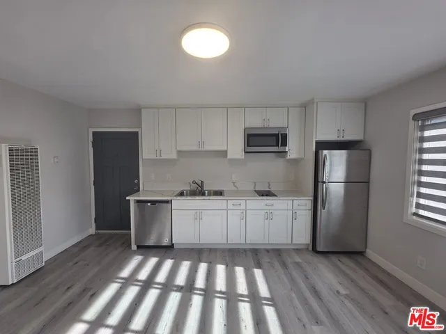 a kitchen with a refrigerator and a sink