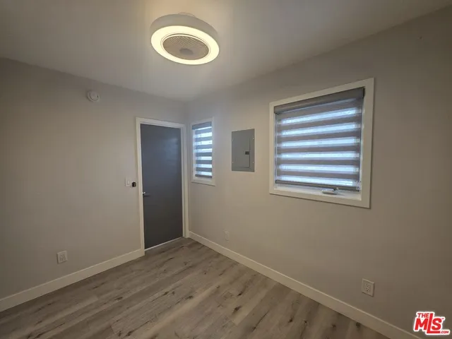 a view of a room with wooden floor and window