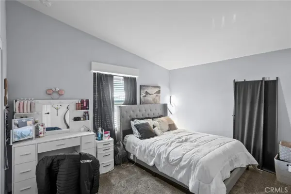 a bedroom with bed and a couch