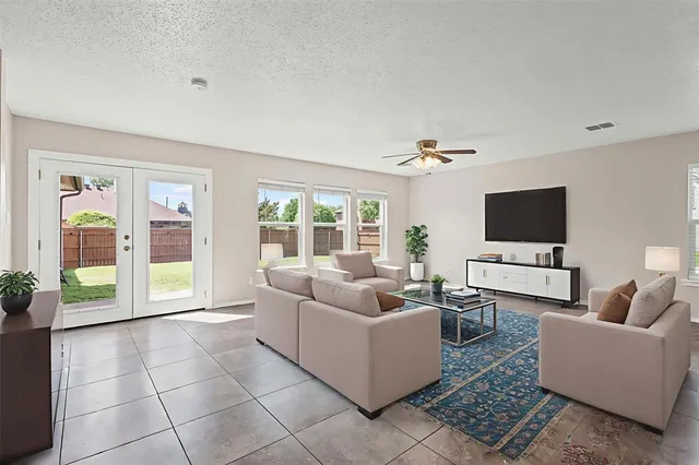 a kitchen with stainless steel appliances granite countertop a stove a sink a dining table and chairs