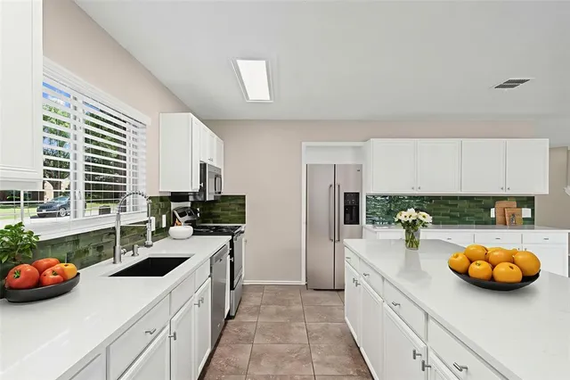 a dining room with furniture a chandelier and wooden floor