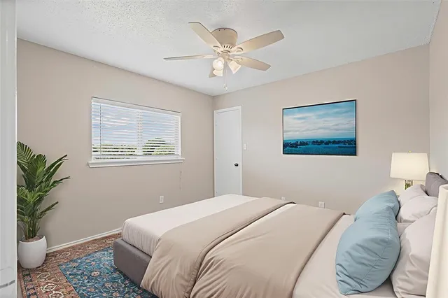 a bedroom with a large bed and a window