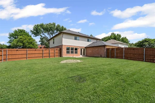 a backyard of a house with lots of green space