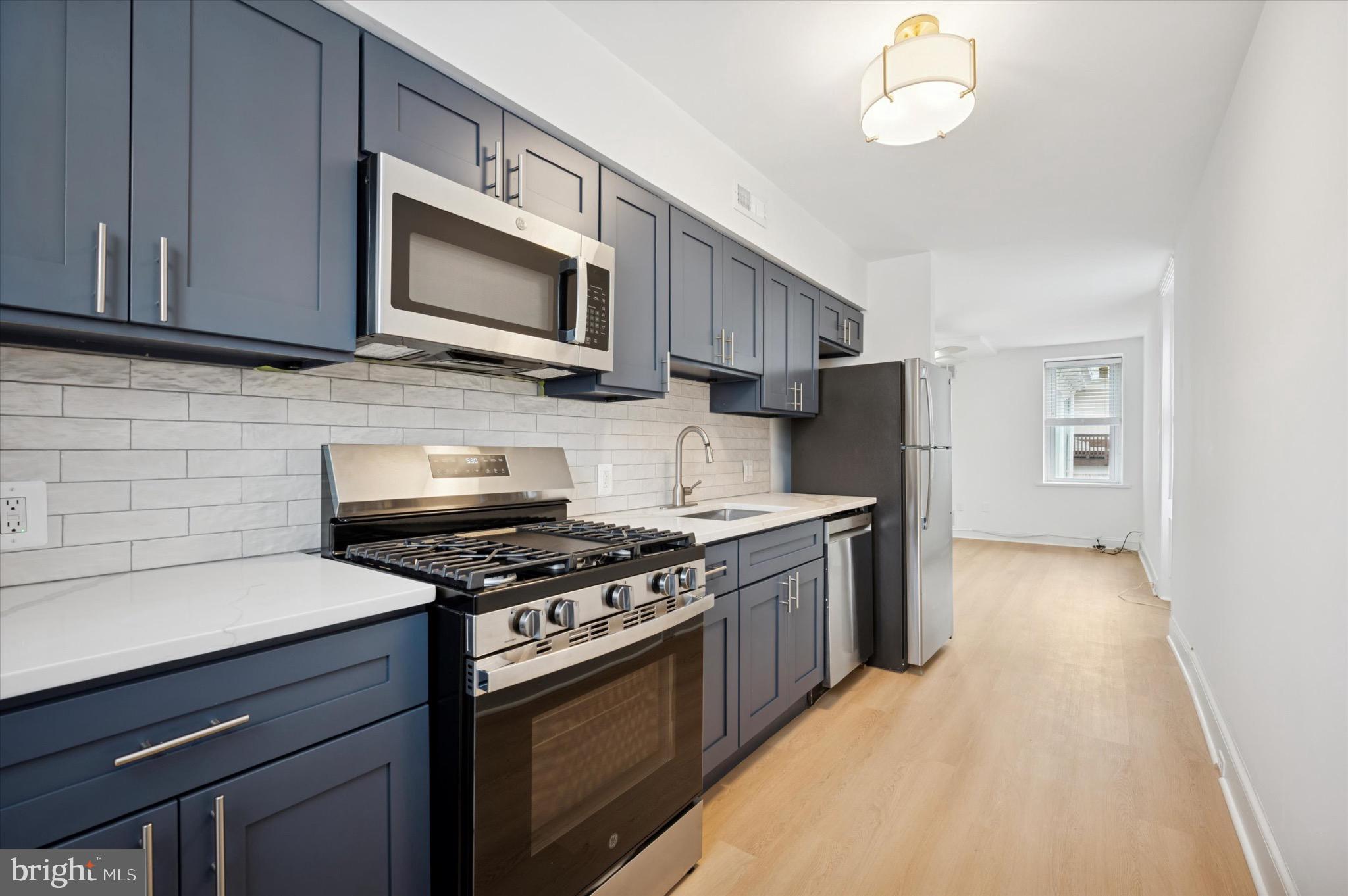 a kitchen with stainless steel appliances wooden cabinets and a stove top oven