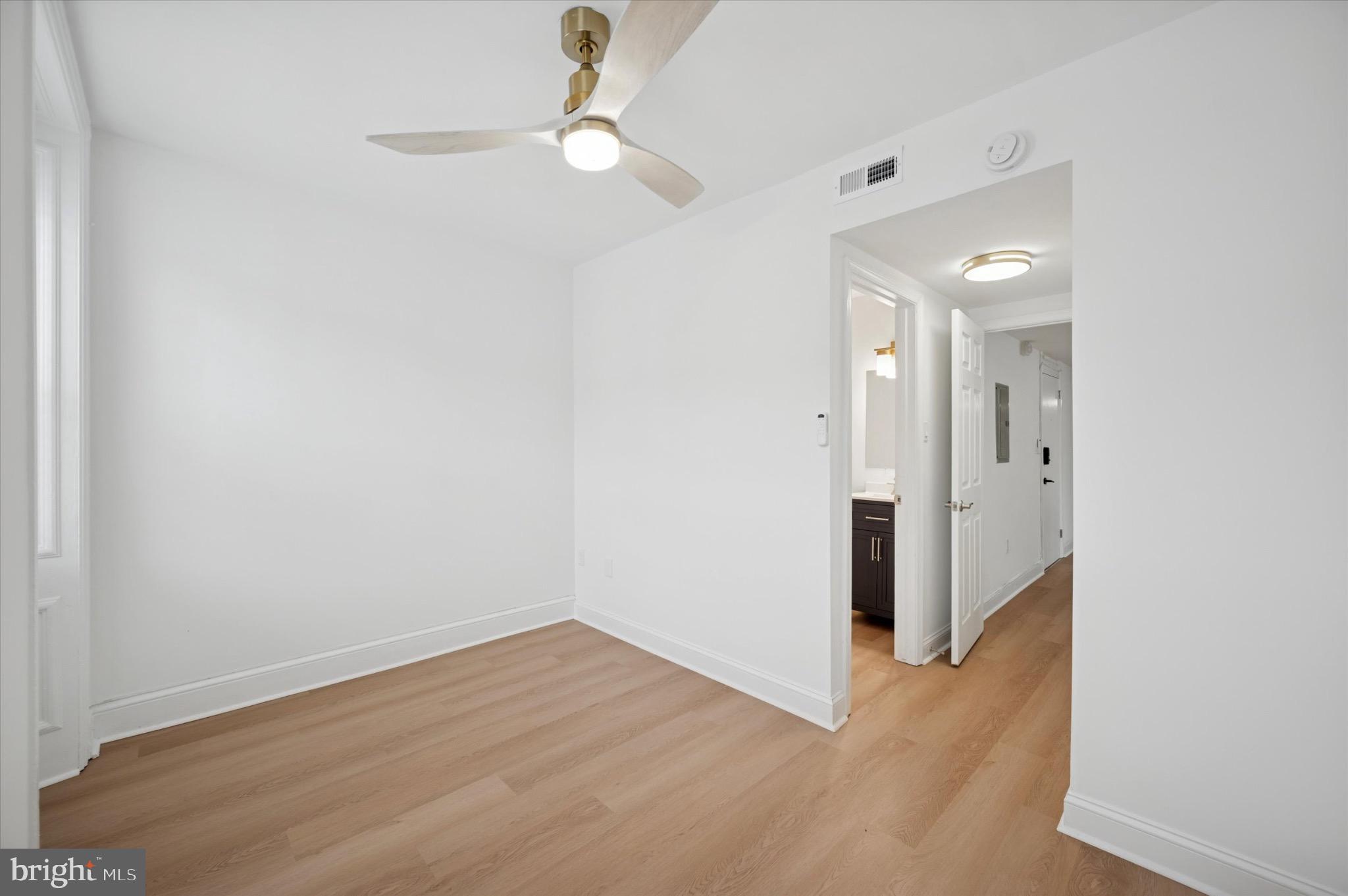 3869 Terrace Street, Unit 2 Philadelphia, PA 19128 - Photo 11 of 16 an empty room with wooden floor and ceiling fan