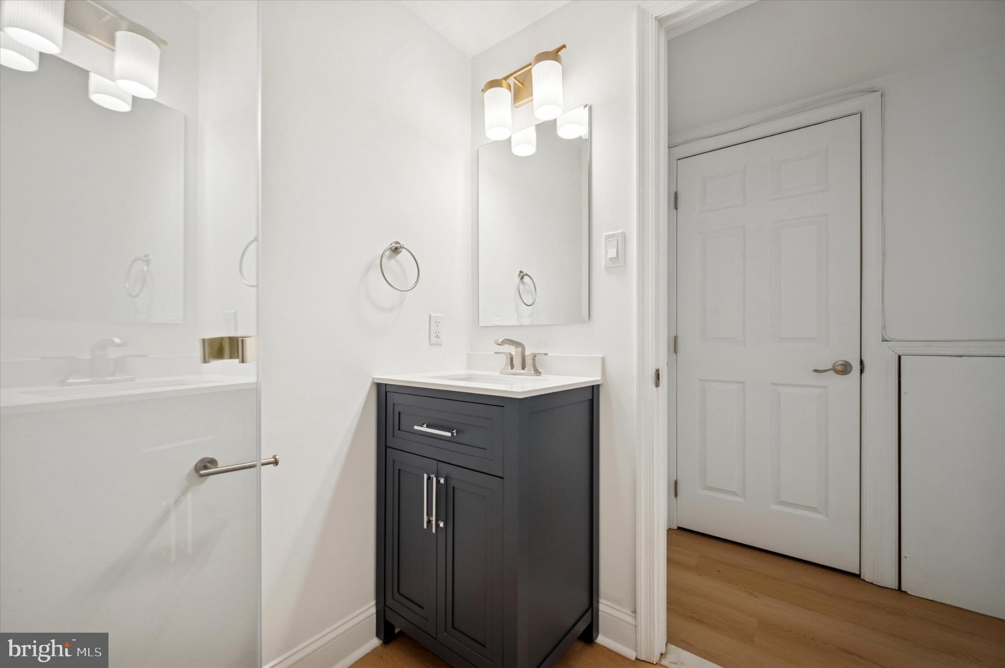 3869 Terrace Street, Unit 2 Philadelphia, PA 19128 - Photo 7 of 16 a bathroom with a sink a mirror and a shower