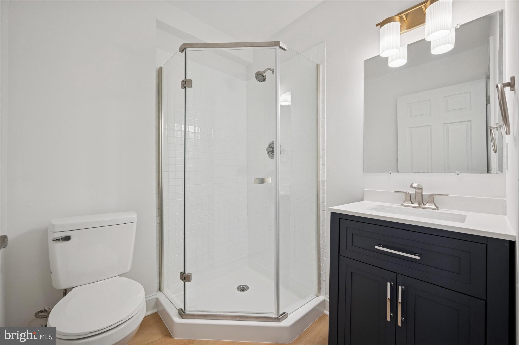 3869 Terrace Street, Unit 2 Philadelphia, PA 19128 - Photo 9 of 16 a bathroom with a toilet a sink and shower
