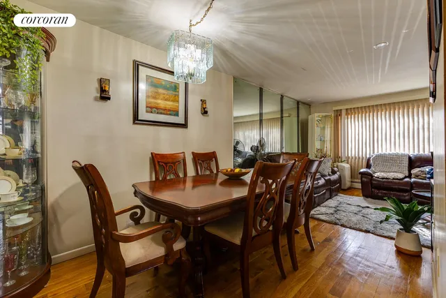 a view of a dining room with furniture a chandelier and wooden floor