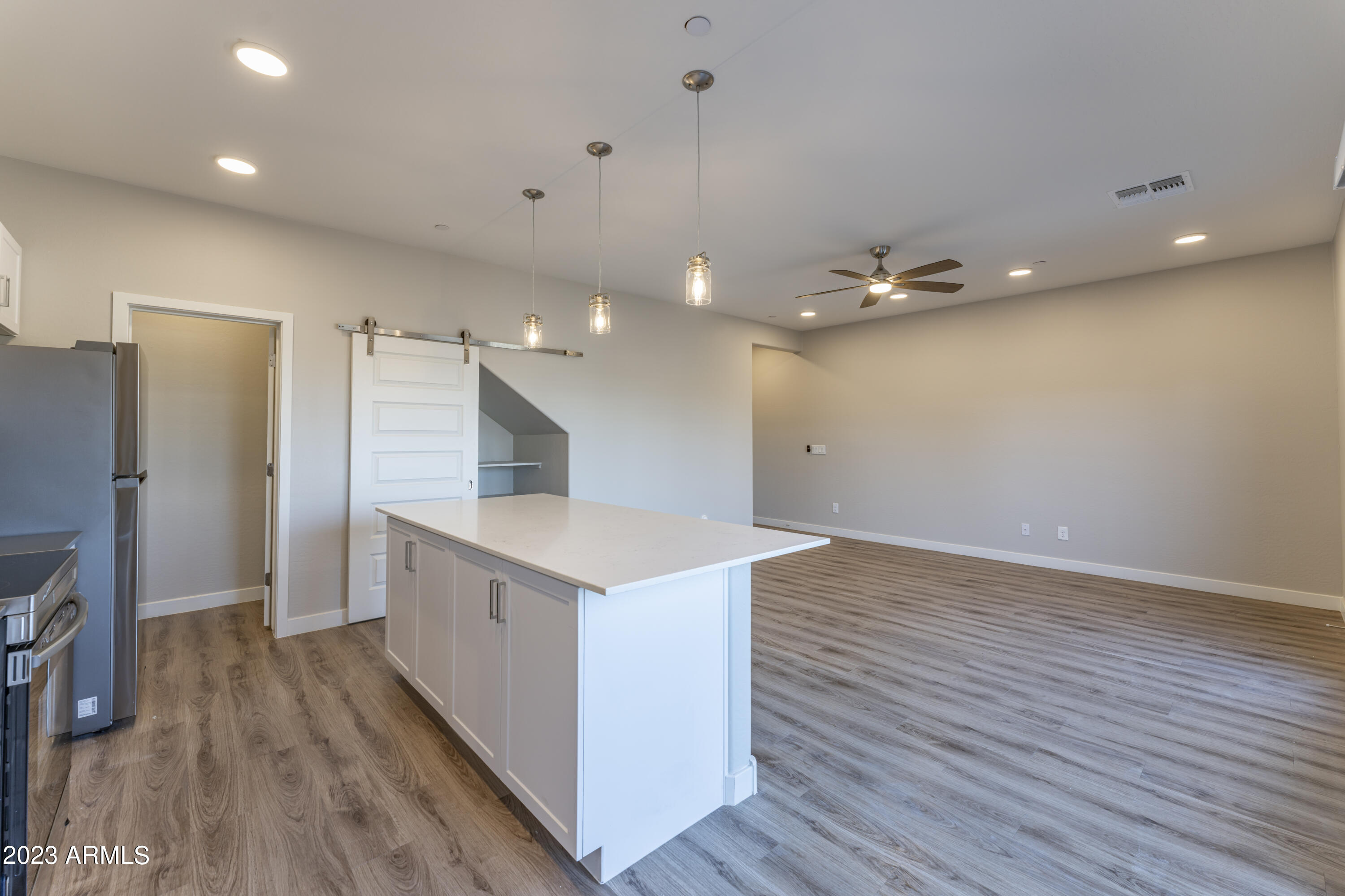 432 South 32nd Street, Unit 104 Mesa, AZ 85204 - Photo 18 of 75 wooden floor in an empty room with a kitchen