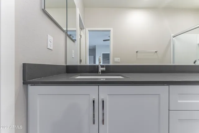 a view of an empty room with a ceiling fan