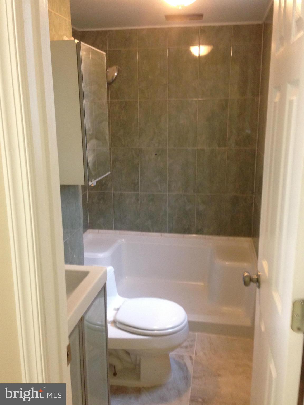 9501 Juliette Drive Clinton, MD 20735 - Photo 22 of 27 a bathroom with a toilet and shower