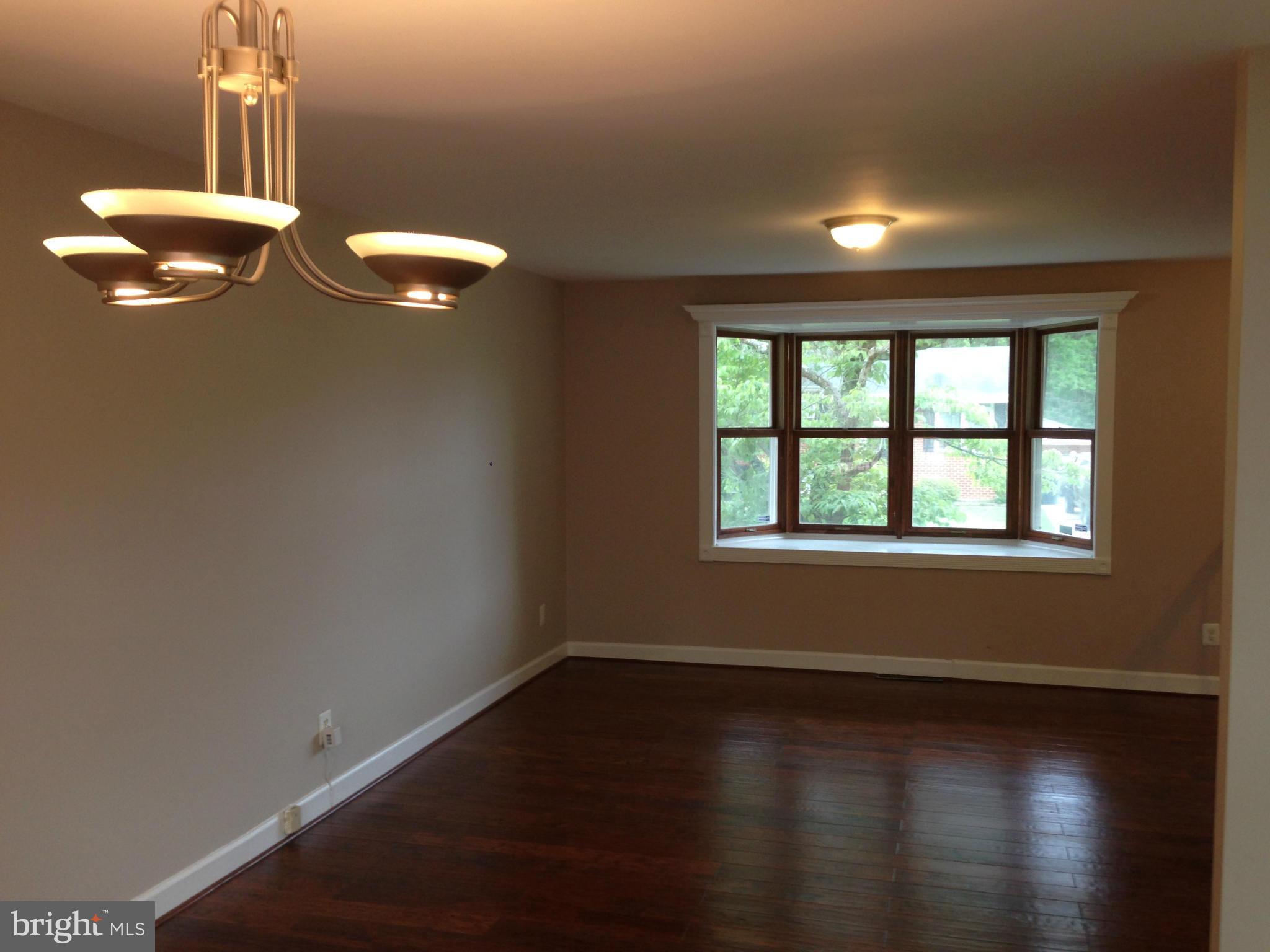 9501 Juliette Drive Clinton, MD 20735 - Photo 5 of 27 an empty room with wooden floor and windows
