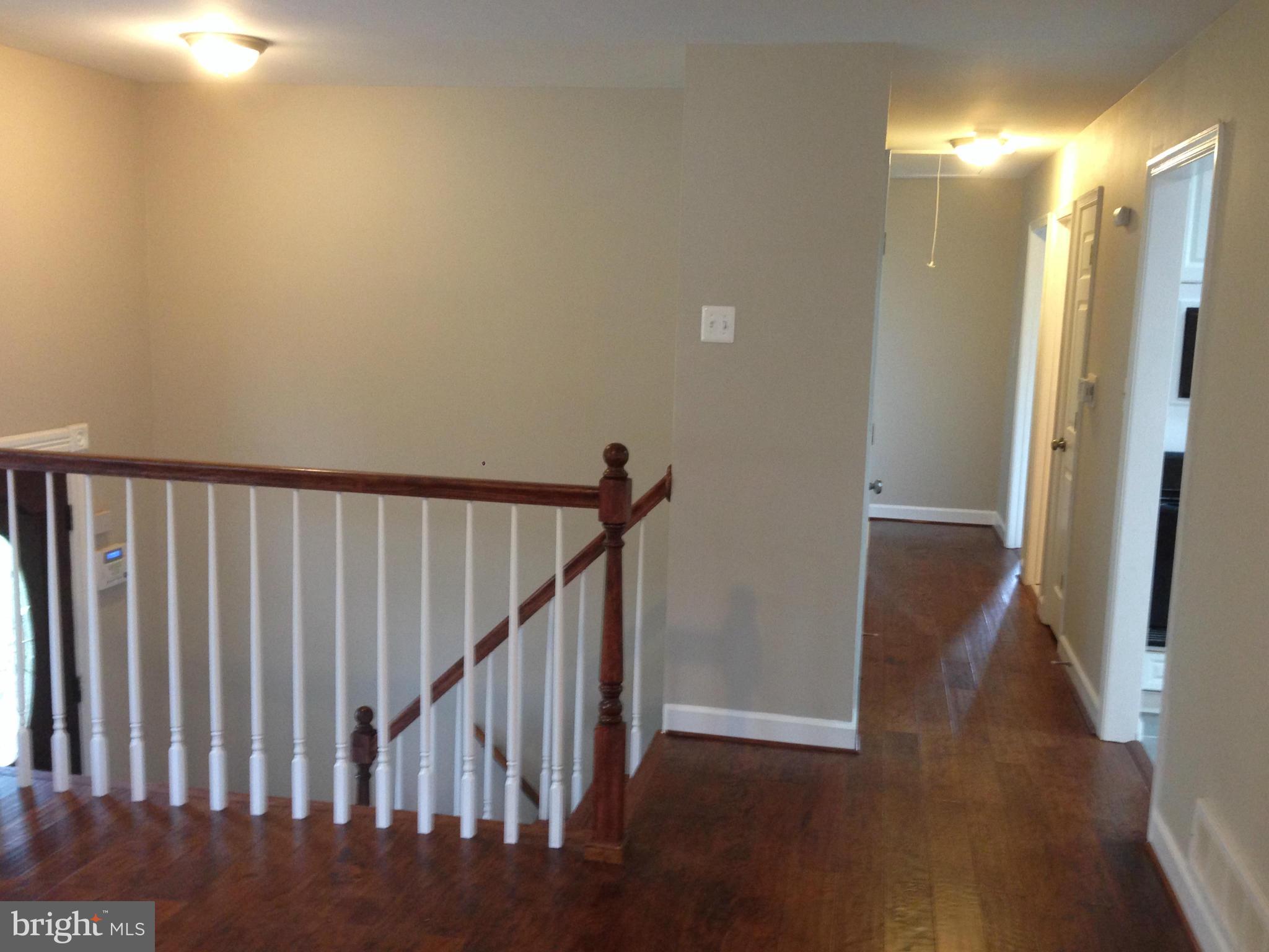 9501 Juliette Drive Clinton, MD 20735 - Photo 8 of 27 a view of a hallway with wooden floor