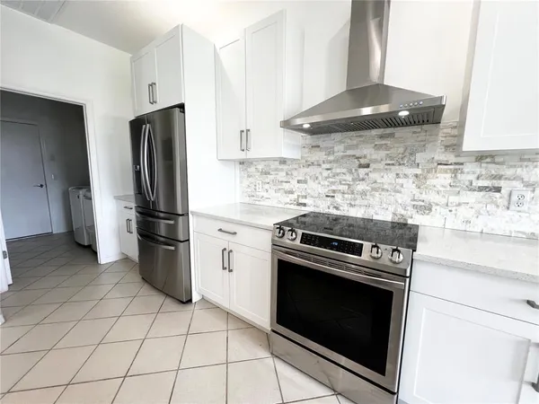 a kitchen with a stove a refrigerator and a sink
