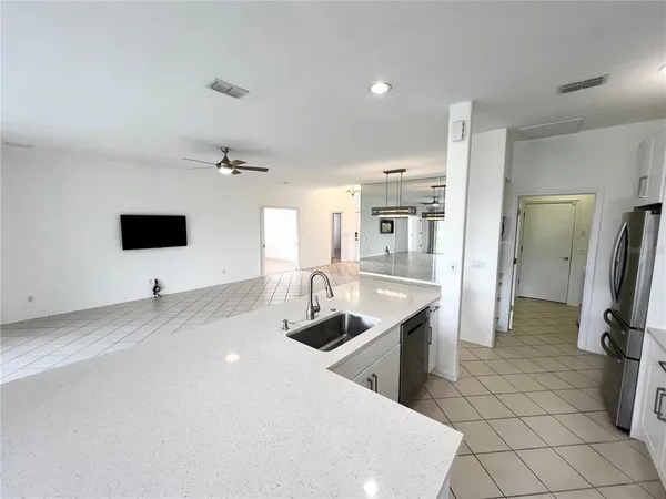 a kitchen with stainless steel appliances a sink a stove a refrigerator and cabinets