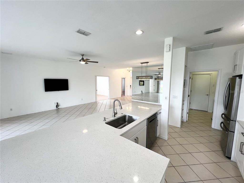 7463 Ridge Road Sarasota, FL 34238 - Photo 14 of 30 a kitchen with stainless steel appliances a sink a stove a refrigerator and cabinets